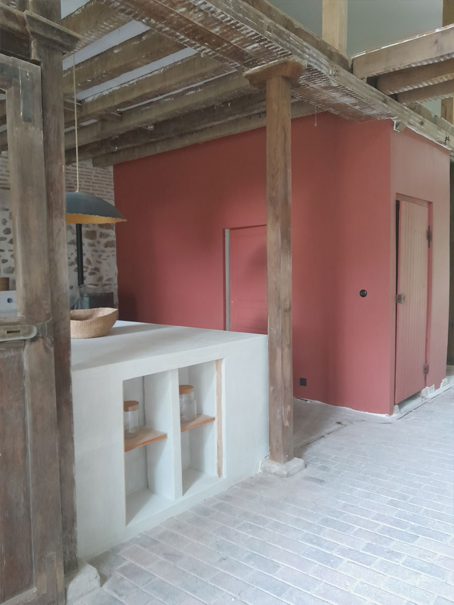 masonry kitchen partially separated by an old horse stall