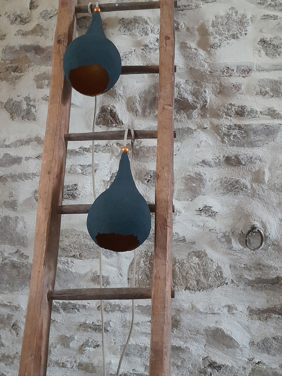 detail of two lights hanging from a wooden ladder